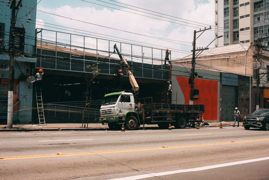 Construction workers operating machinery at a busy urban city construction site